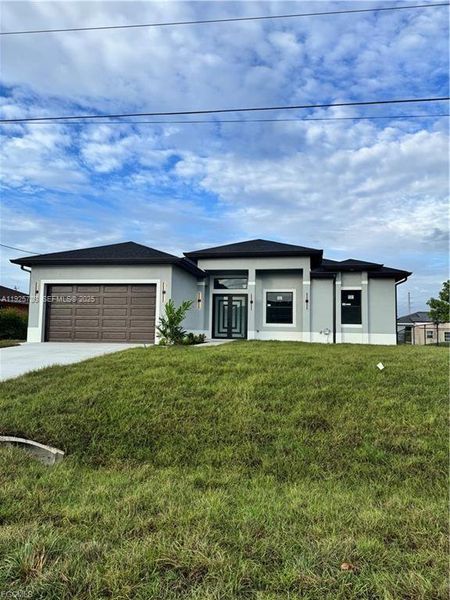 Front exterior of a new home in , Lehigh Acres, FL, highlighting curb appeal (Image 1). Front exterior of a new home in , Lehigh Acres, FL, highlighting curb appeal (Image 1).