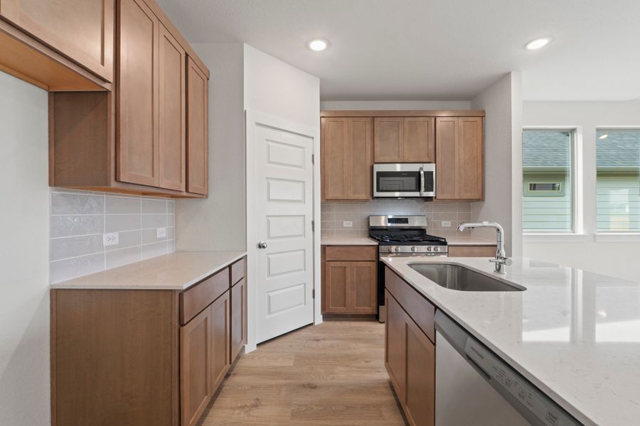 Kitchen in the Pearl home plan by Trophy Signature Homes – REPRESENTATIVE PHOTO