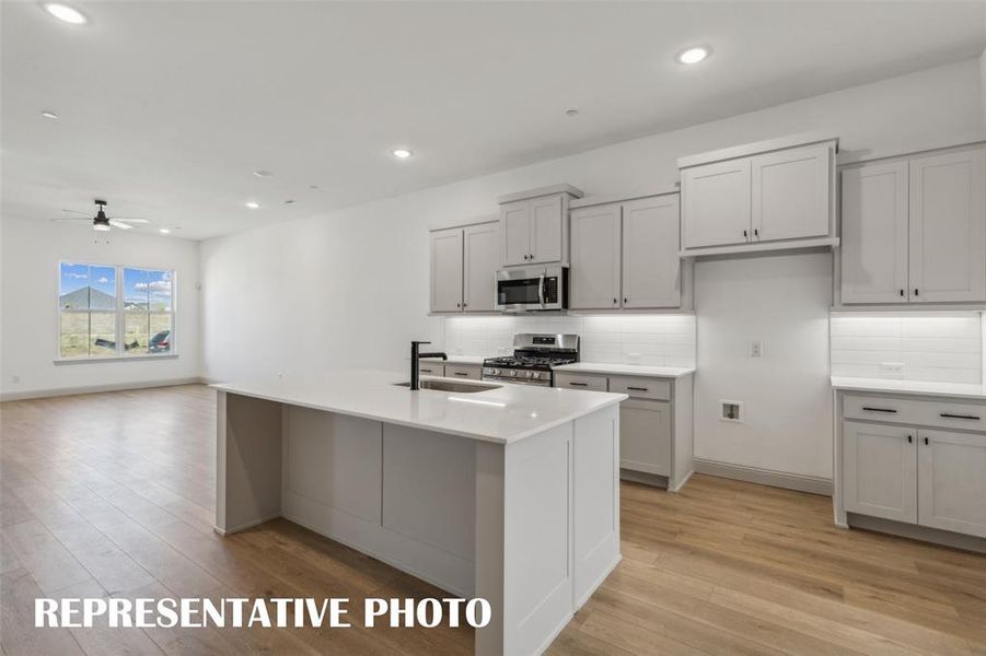 Your new kitchen features a spacious island perfect for a quick bite or homework station!  REPRESENTATIVE PHOTO