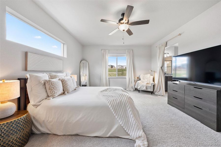 Serene primary bedroom with ensuite 5-piece bath, high ceiling, beautiful windows and views.