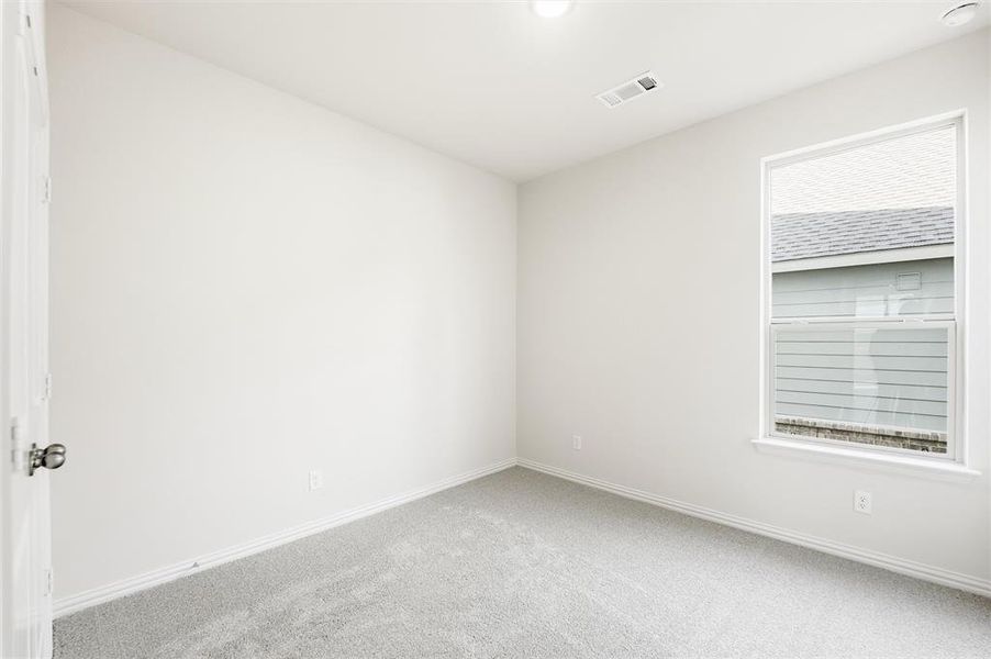 Carpeted empty room with baseboards