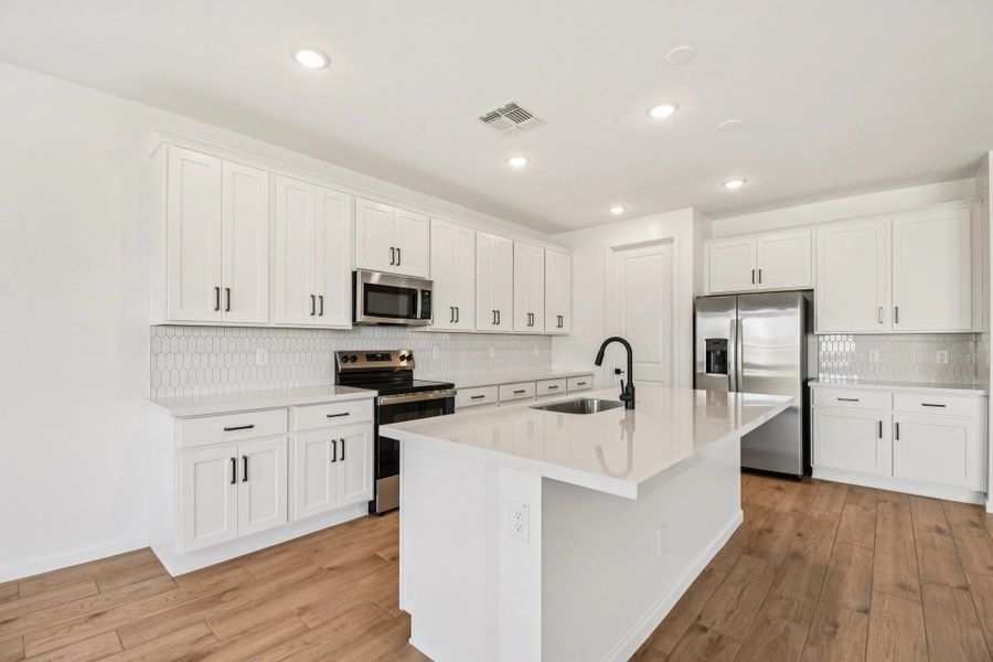 Kitchen featuring the Harmony Collection. Not actual home, finishes may vary by community.