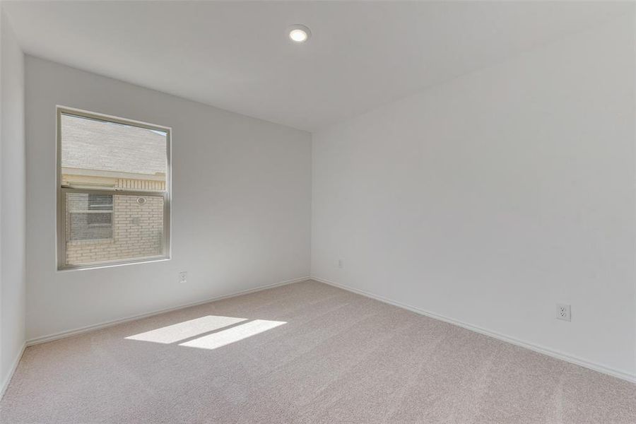 Unfurnished room with light colored carpet