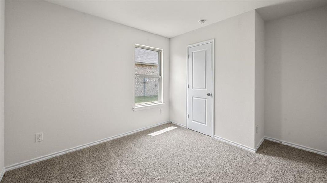 Unfurnished room with carpet floors and baseboards