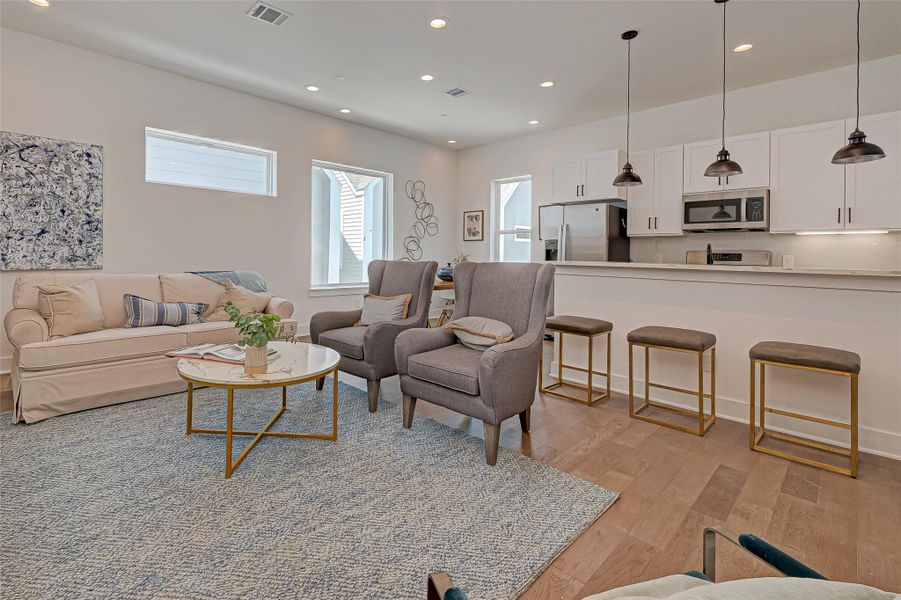 Another angle on the main living area highlights abundant natural light and flexible space for art, media, and lounging. A perfect balance of modern elegance and inviting comfort for daily living.