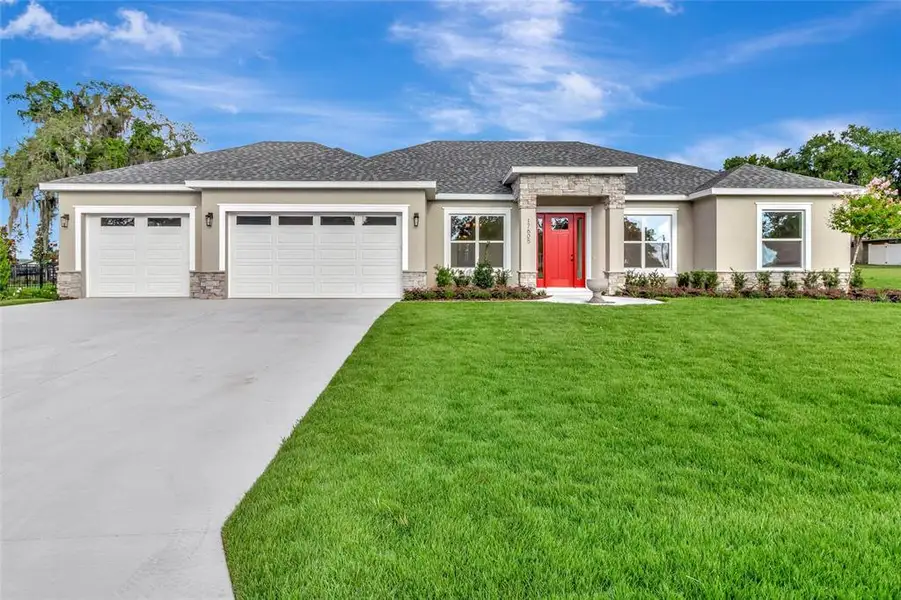 Front exterior of a new home in , Montverde, FL, highlighting curb appeal (Image 21). Front exterior of a new home in , Montverde, FL, highlighting curb appeal (Image 21).