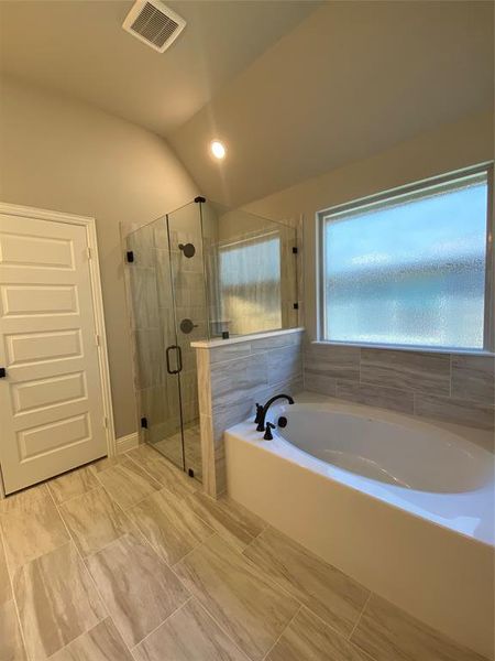 Master bath garden tub & frameless glass shower with dropped tile pan.