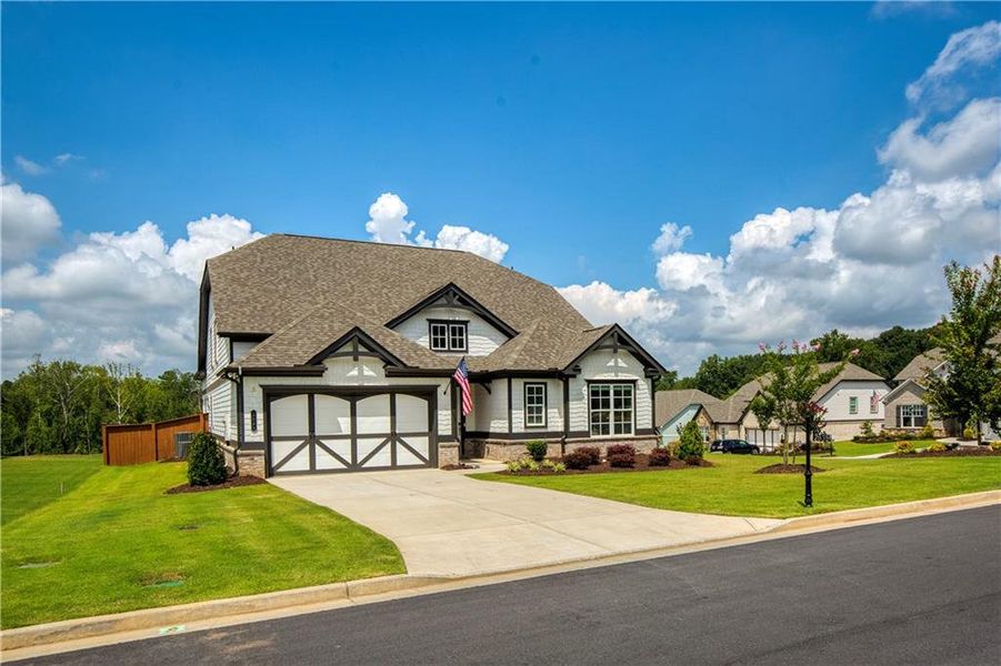 Front exterior of a new home in Yellowstone Farms, Cumming, GA, highlighting curb appeal (Image 2). Front exterior of a new home in Yellowstone Farms, Cumming, GA, highlighting curb appeal (Image 2).