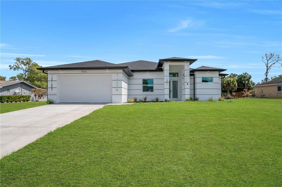 Front exterior of a new home in , Lehigh Acres, FL, highlighting curb appeal (Image 26). Front exterior of a new home in , Lehigh Acres, FL, highlighting curb appeal (Image 26).