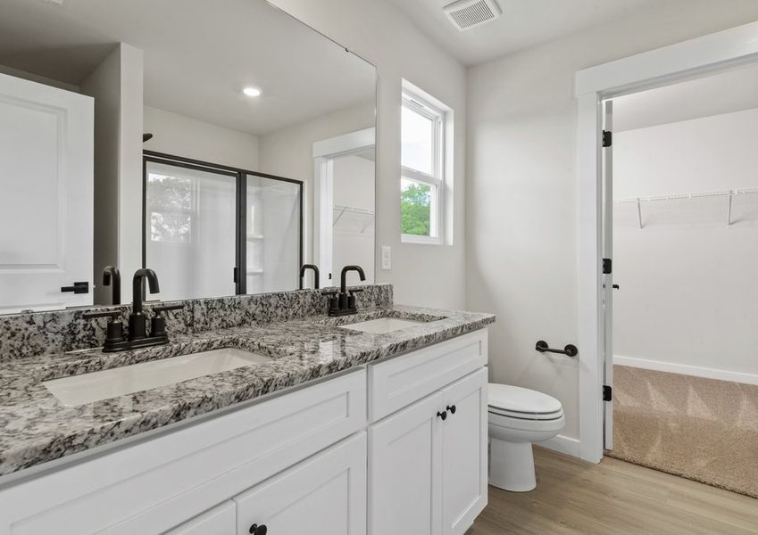 This bathroom has a glass-enclosed shower