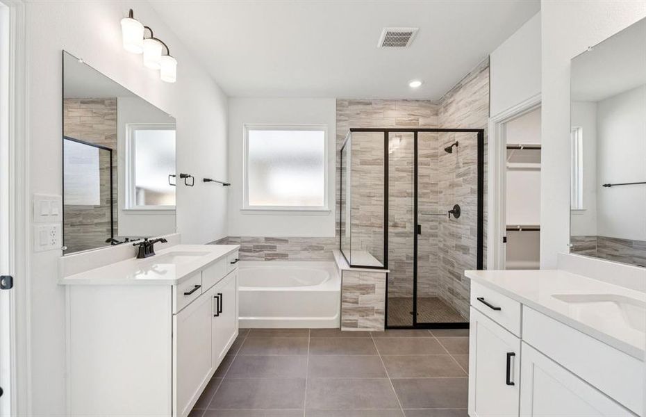 Luxurious owner's bath complete with double sinks and a generous shower Luxurious owner's bath complete with double sinks and a generous shower