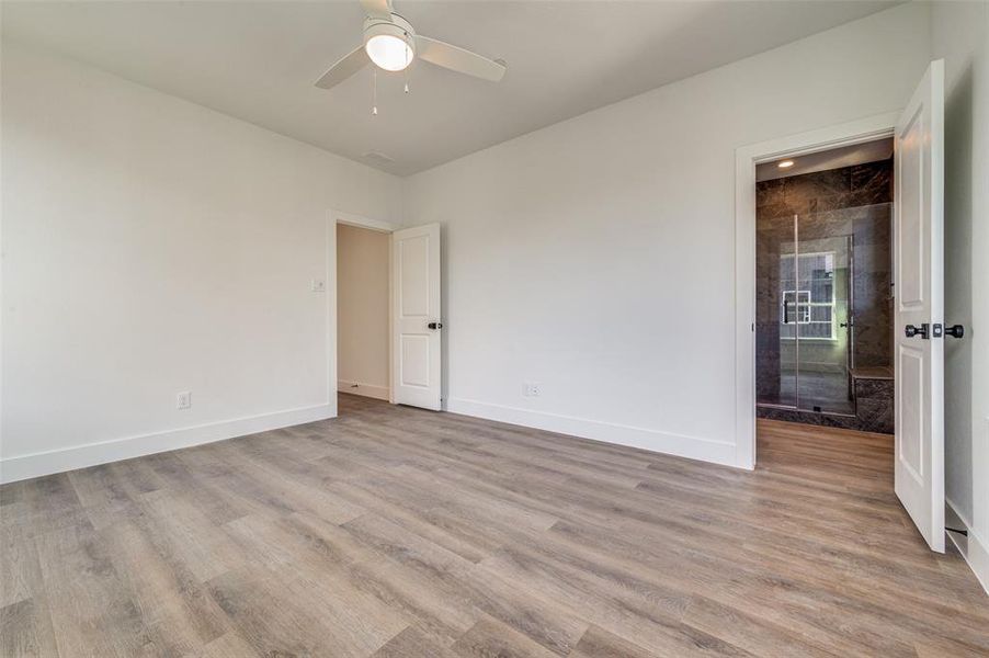 Empty room with wood-type flooring and ceiling fan