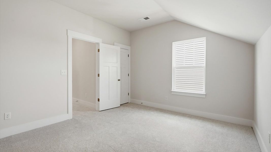 Refined bedroom design with a large window for daylight-filled mornings and peaceful views by DRB Homes Refined bedroom design with a large window for daylight-filled mornings and peaceful views by DRB Homes