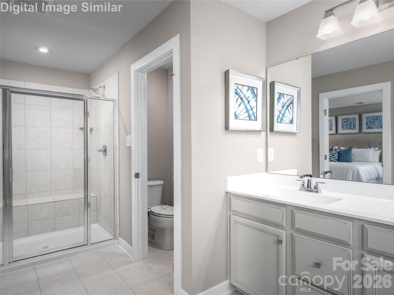 Designed for comfort — dual sinks, a private water closet, and a spacious walk-in shower for your daily living.
