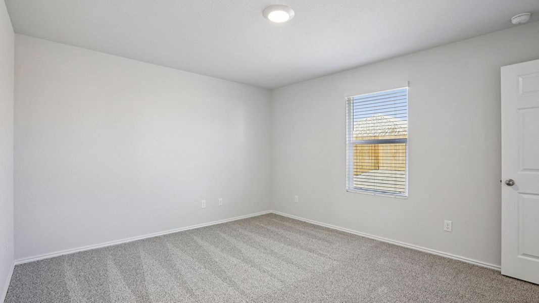 Spare room featuring carpet floors and baseboards