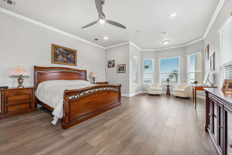 Natural light floods this spacious primary bedroom, offering ample space for rest and a private sitting area. Natural light floods this spacious primary bedroom, offering ample space for rest and a private sitting area.