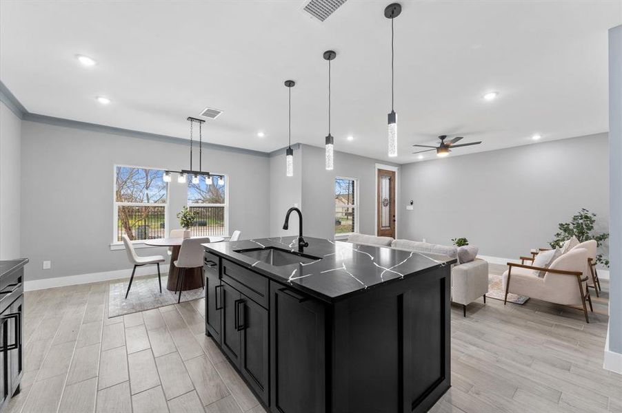 A spacious kitchen island with quartz countertops and additional seating