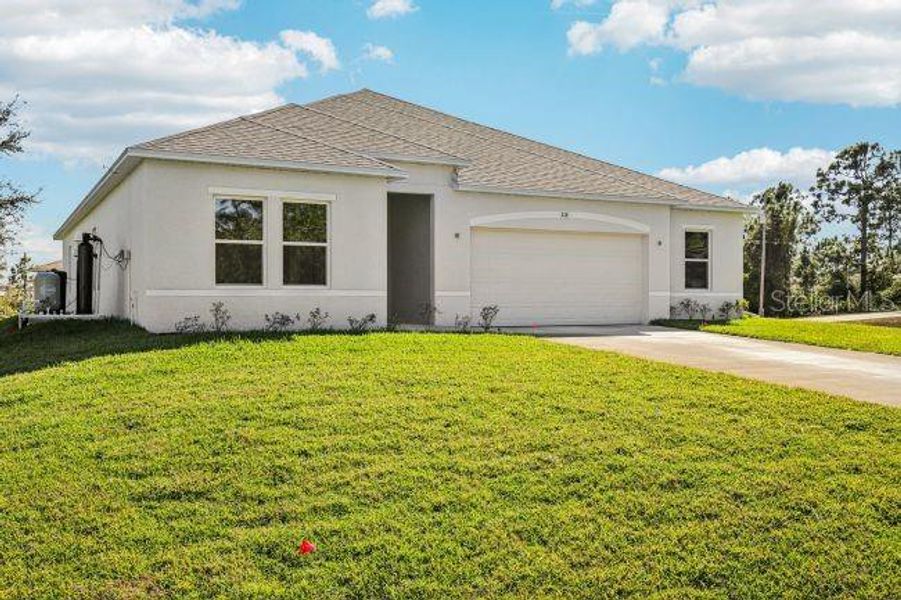 Front exterior of a new home in Royal Highlands, Weeki Wachee, FL, highlighting curb appeal (Image 20).