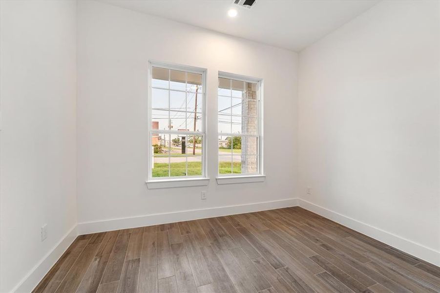 Bedroom 3 with two forward facing windows. No carpet in this whole house!