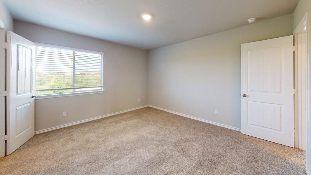Unfurnished bedroom with light carpet and baseboards Unfurnished bedroom with light carpet and baseboards