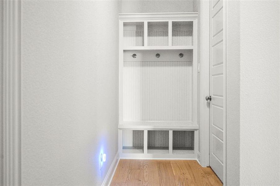 Mudroom with light wood-style flooring and baseboards Mudroom with light wood-style flooring and baseboards