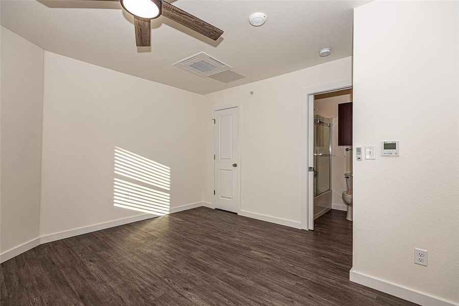 Bedroom with ceiling fan wood-style floors and ensuite bath - 2nd floor