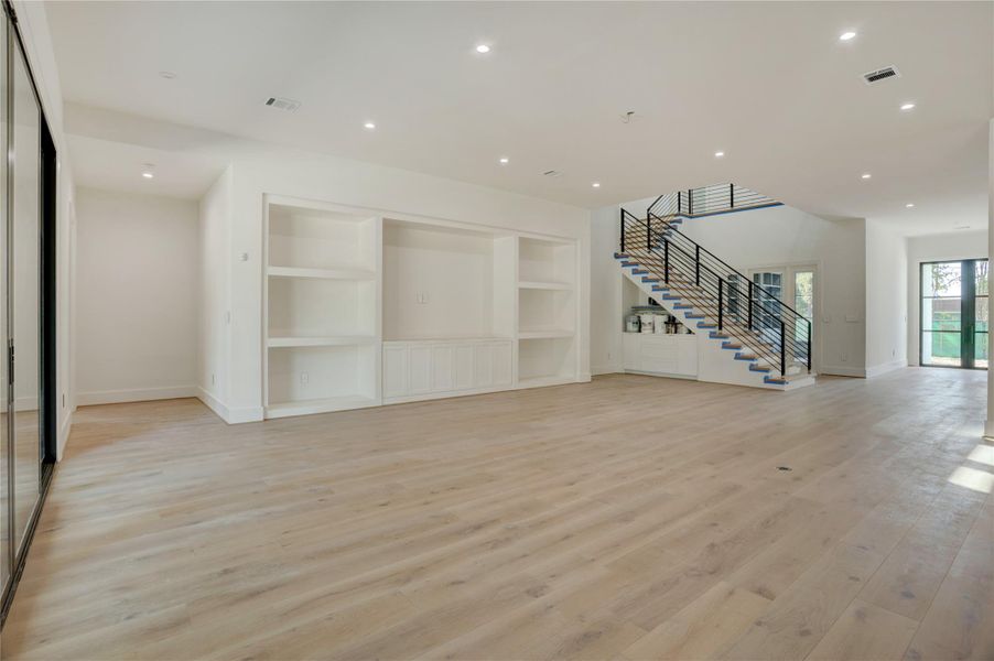 View back to the front door highlighting the built-ins, dry bar, and location of the downstairs study with french doors for privacy. View back to the front door highlighting the built-ins, dry bar, and location of the downstairs study with french doors for privacy.