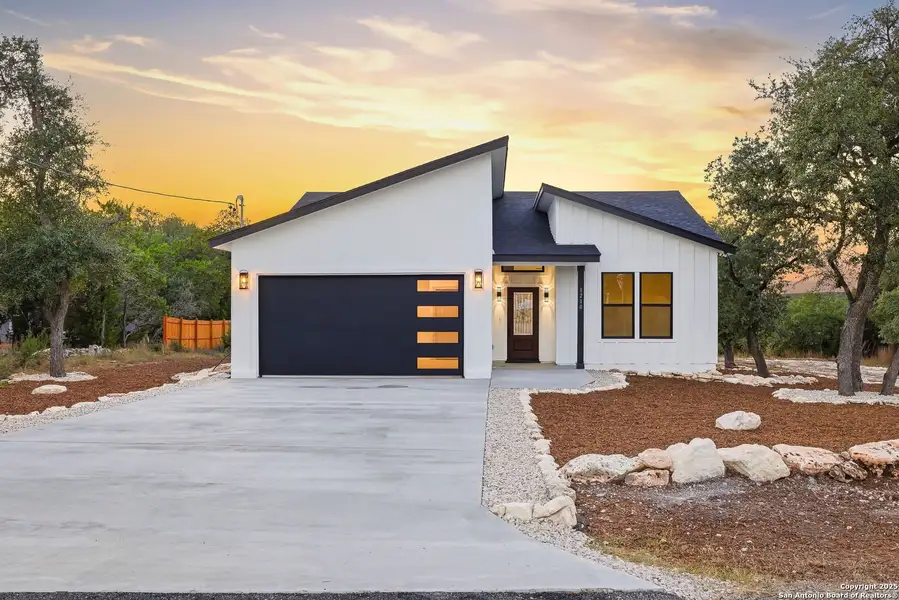 Front exterior of a new home in , Fischer, TX, highlighting curb appeal (Image 1).