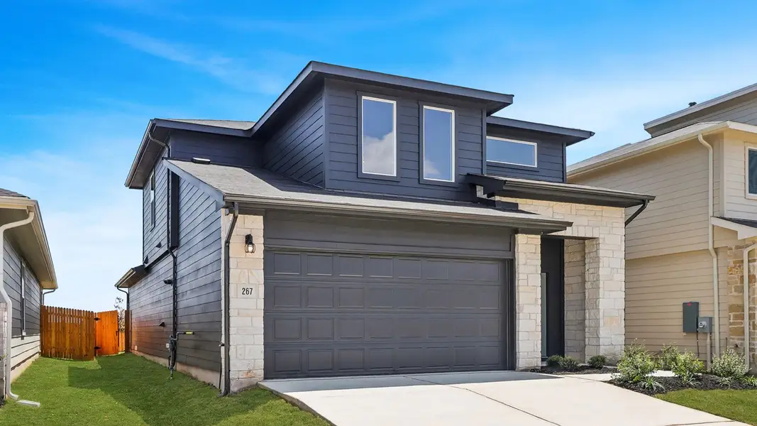 Front exterior of a new home in Southgrove, Kyle, TX, highlighting curb appeal (Image 2).