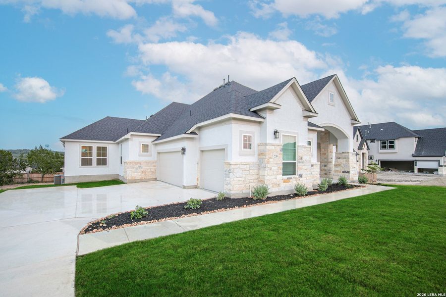 Front exterior of a new home in Caliza Reserve, Boerne, TX, highlighting curb appeal (Image 1). Front exterior of a new home in Caliza Reserve, Boerne, TX, highlighting curb appeal (Image 1).