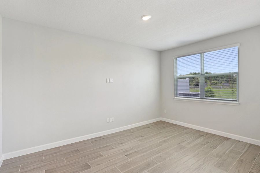 Spacious family room with a large double window -  Representative images and renderings are for illustrative purposes