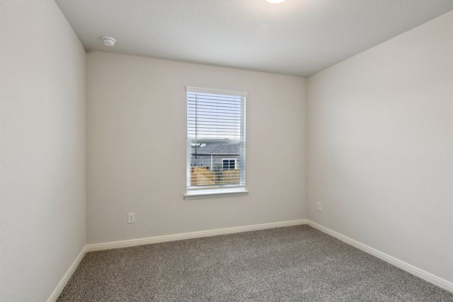 Guest bedroom in the Red River floorplan at a Meritage Homes community.