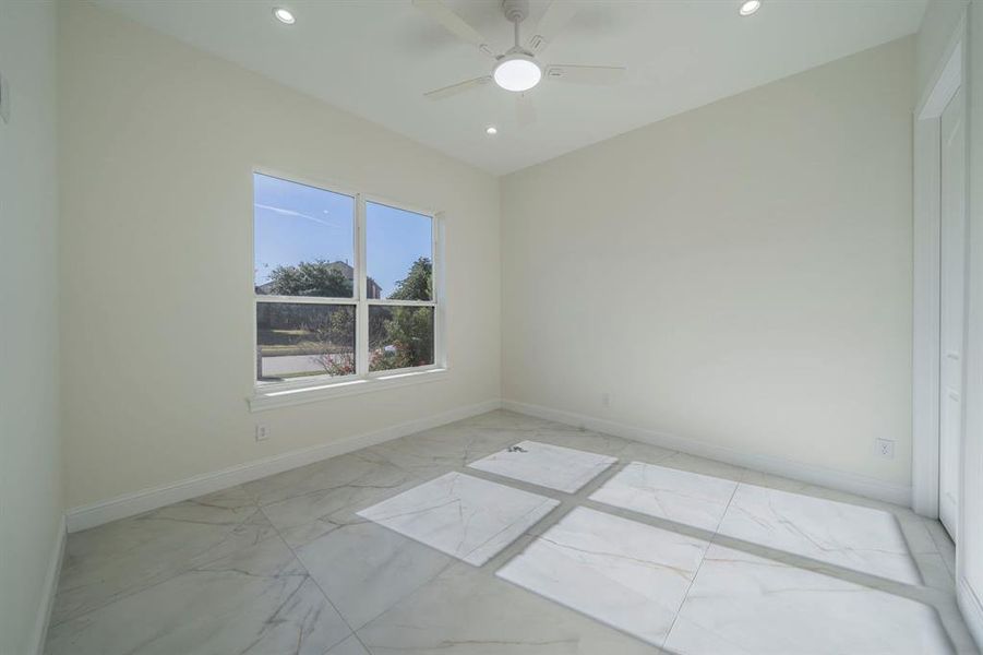 Spare room featuring light marble finish flooring, recessed lighting, and ceiling fan Spare room featuring light marble finish flooring, recessed lighting, and ceiling fan