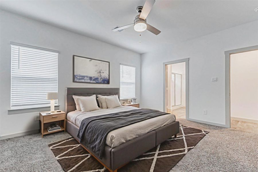 This well-proportioned primary bedroom flows directly into a private en-suite bath, perfect for comfort and privacy. Plush carpeting, dual windows, and a modern ceiling fan make it an ideal space for winding down or waking up refreshed. This well-proportioned primary bedroom flows directly into a private en-suite bath, perfect for comfort and privacy. Plush carpeting, dual windows, and a modern ceiling fan make it an ideal space for winding down or waking up refreshed.