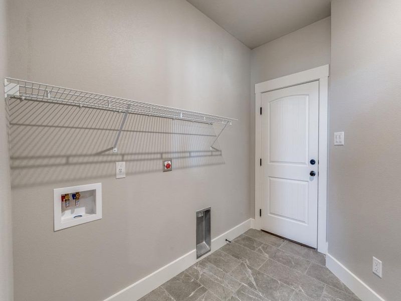 Clothes washing area featuring baseboards, laundry area, and hookup for a washing machine