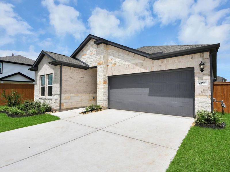 Front exterior of a new home in Sunterra, Katy, TX, highlighting curb appeal (Image 2). Front exterior of a new home in Sunterra, Katy, TX, highlighting curb appeal (Image 2).