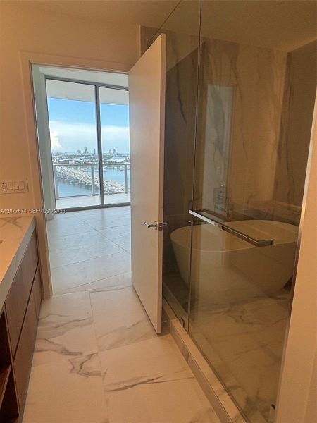Primary Bathroom with Glass Shower, Soaking Tub and Bay Views