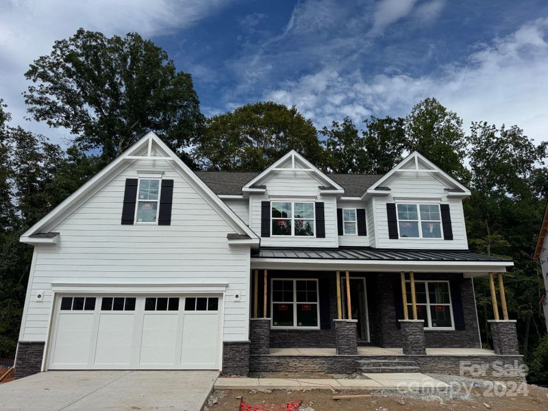 Homesite 28 features a Charleston D floorplan with front-load garage.