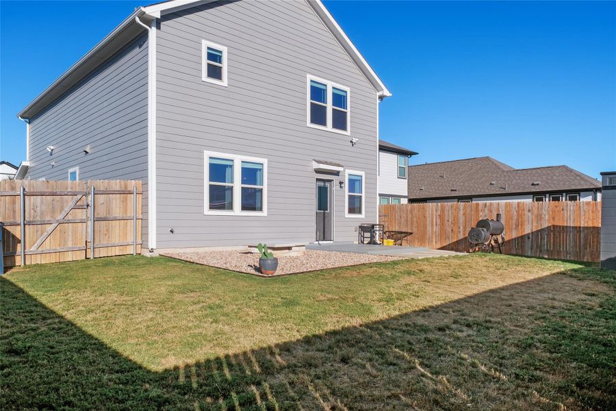 Back of property with a patio area and a fenced backyard