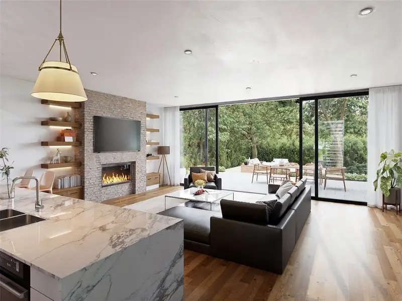 Living area featuring wood-finish flooring, a stone-clad fireplace with a built-in linear electric firebox, and floor-to-ceiling glass doors opening to an outdoor patio
