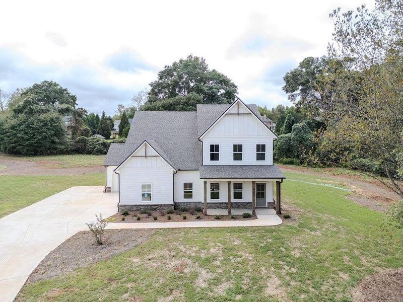 Front exterior of a new home in , Hoschton, GA, highlighting curb appeal (Image 27).