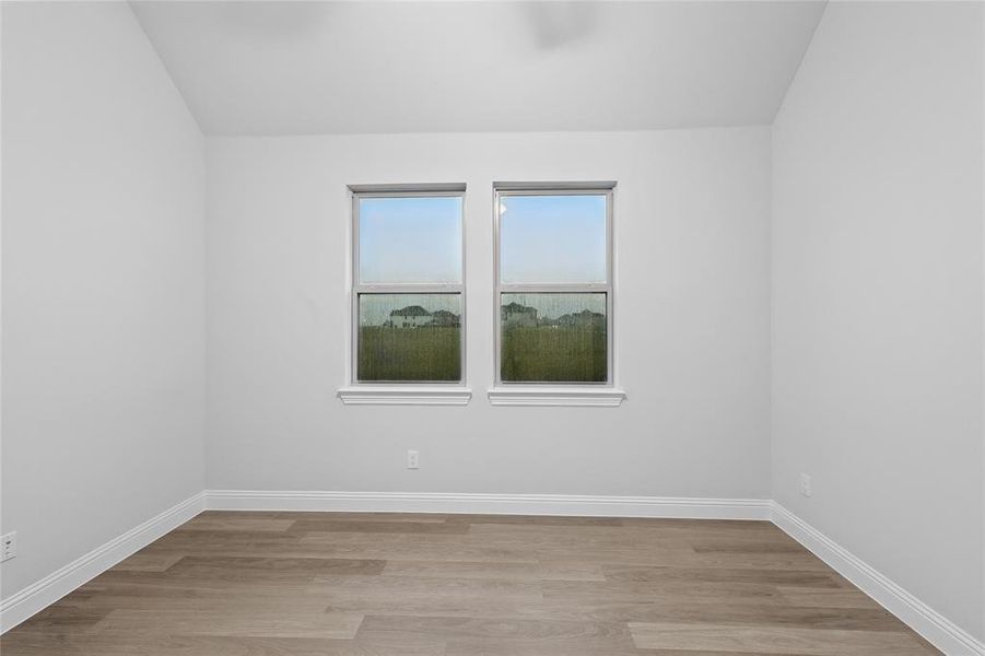 Spare room featuring light wood-style flooring and baseboards Spare room featuring light wood-style flooring and baseboards