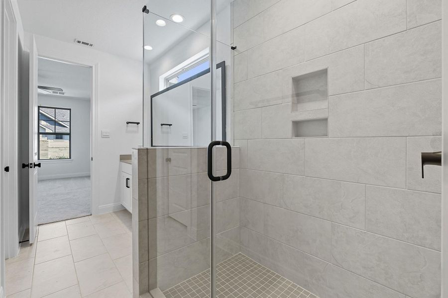 Full bath with vanity, a stall shower, light tile patterned flooring, and recessed lighting