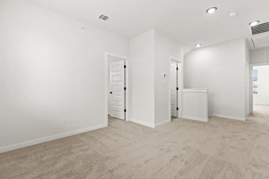A well-lit interior space offers a neutral palette, awaiting personalized touches. A well-lit interior space offers a neutral palette, awaiting personalized touches.
