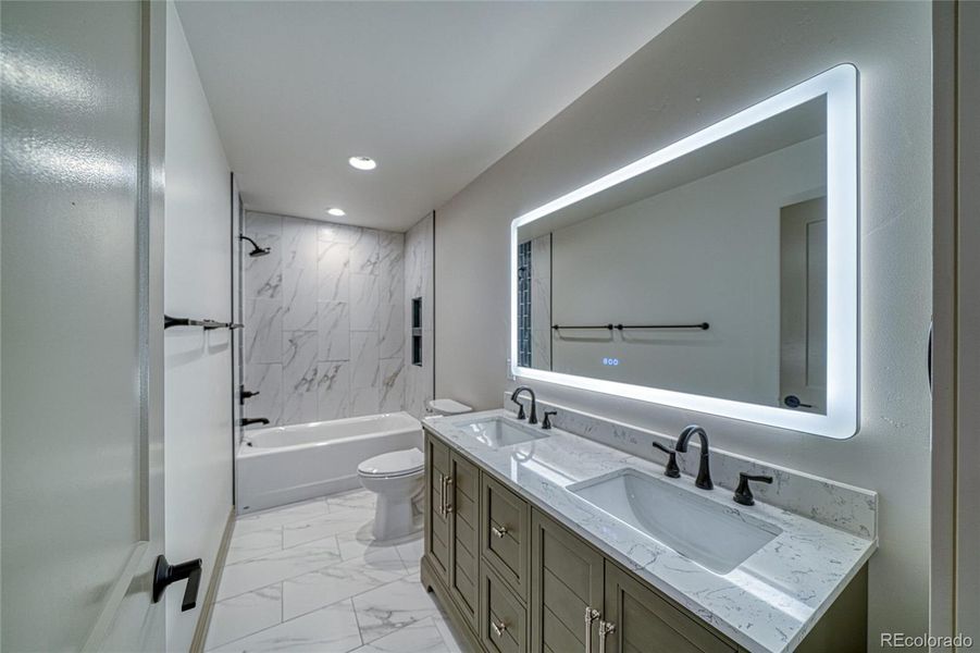 Guest bathroom is a full bathroom that is a full bath and spacious.