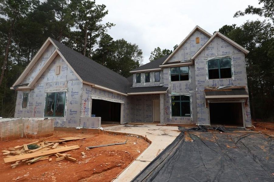 Front exterior of a new home in The Woodlands Hills 70’, Willis, TX, highlighting curb appeal (Image 13). Front exterior of a new home in The Woodlands Hills 70’, Willis, TX, highlighting curb appeal (Image 13).