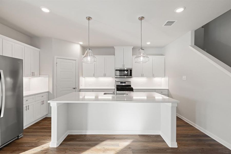 The oversized island is the hub of your new dream kitchen and the perfect place for friends and family to gahter!