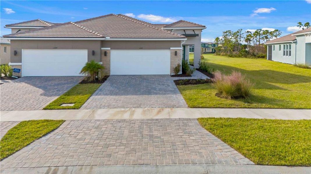 Front exterior of a new home in , Venice, FL, highlighting curb appeal (Image 26). Front exterior of a new home in , Venice, FL, highlighting curb appeal (Image 26).