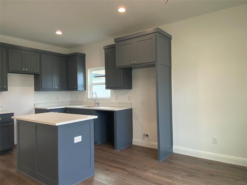 Kitchen featuring dark wood-style floors, recessed lighting, and a center island Kitchen featuring dark wood-style floors, recessed lighting, and a center island