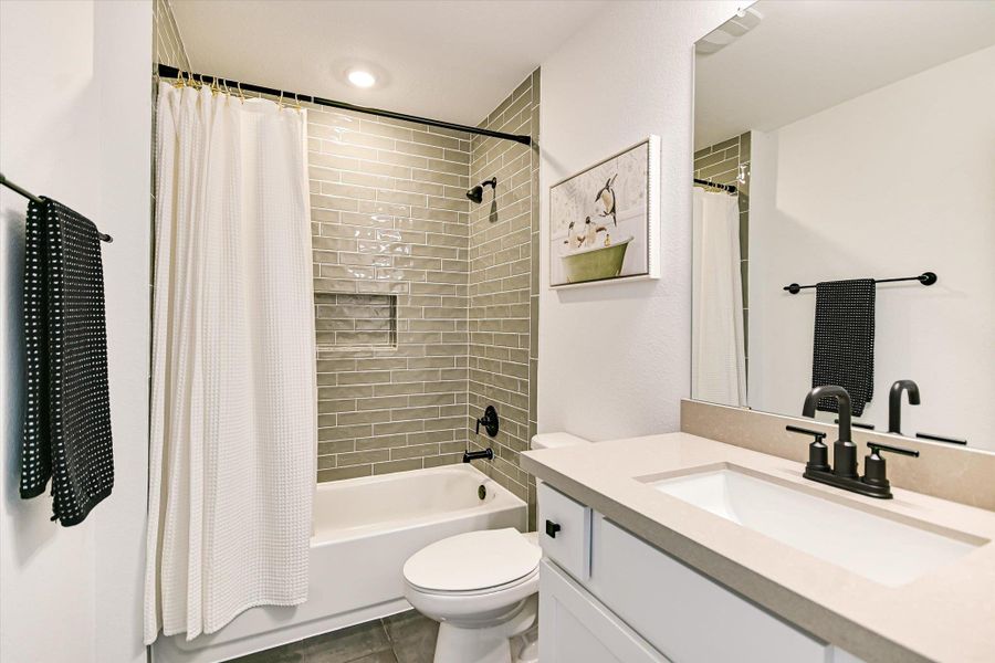 Bathroom with a shower/ bath tub combination for children who love playing with their water toys and sticking letters/animals/       numbers on the tile wall. Plus, an easy cleanup when kids are done and ready for bed.